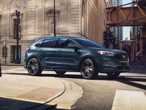 2024 Ford Edge driving around a curb in a city