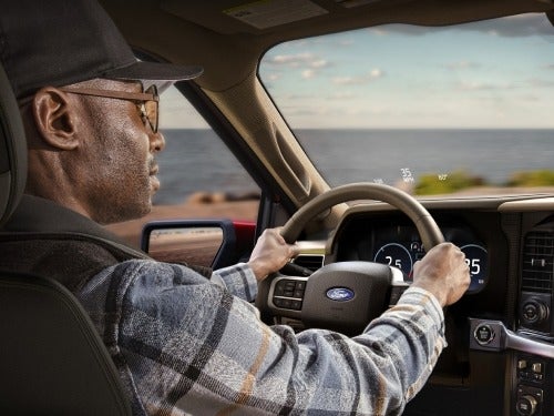 2024 Ford F-150 interior view of man in driver seat with speed limit shown on head up display