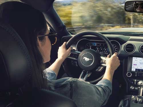 2023 Ford Mustang view of woman driving showing steering wheel and dash area