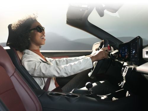 2024 Ford Mustang woman driving with car top off