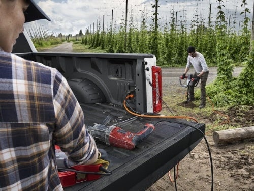 2024 Ford Super Duty view of man using power tool with pro power onboard