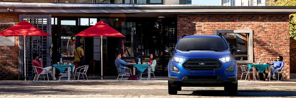Ford parked in front of a restaurant